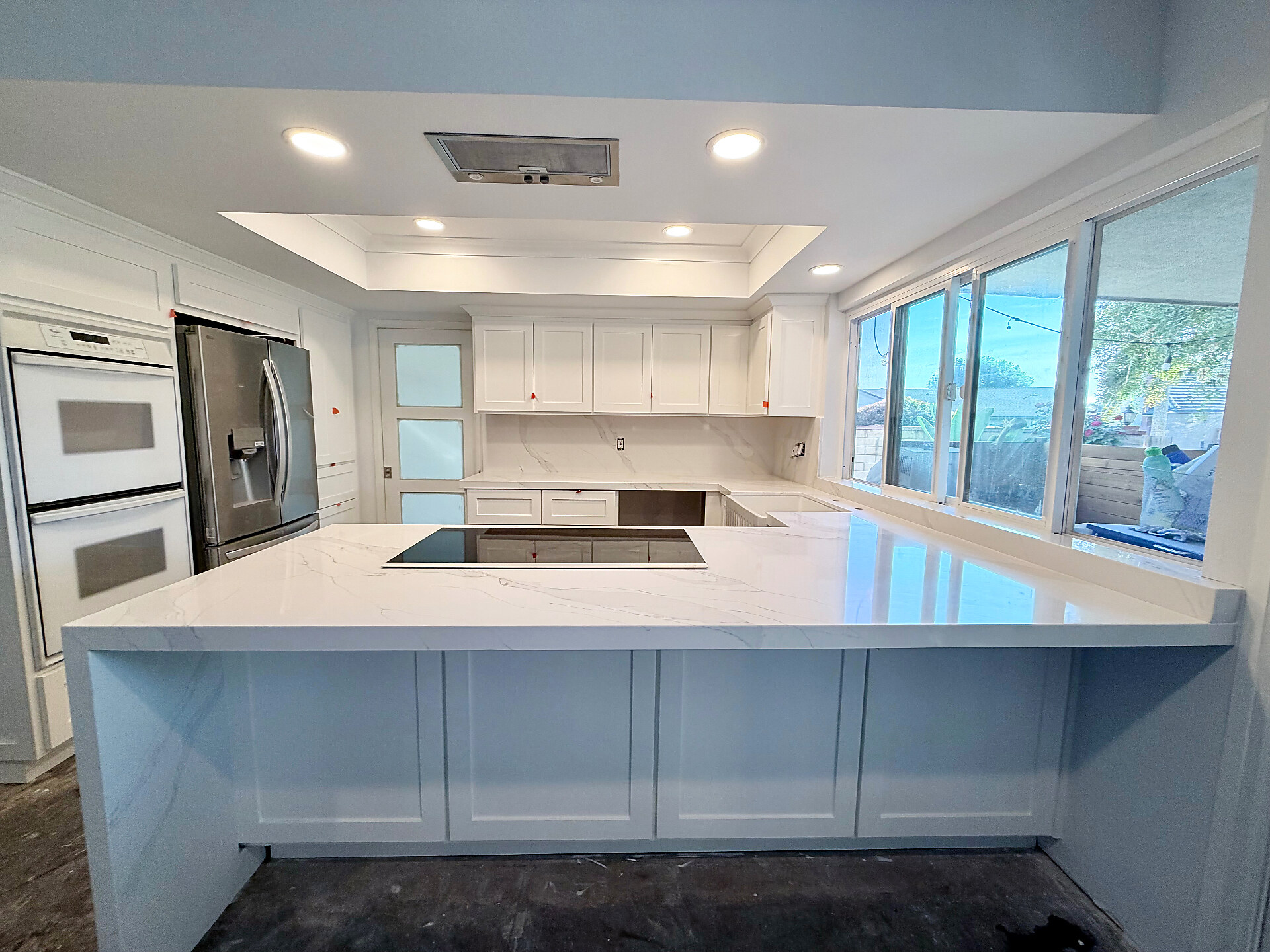 White quartz waterfall island kitchen with calacatta veining — Stoneworks Ventura County install